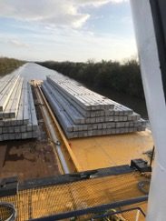 Overhead view of pilings loaded on a barge