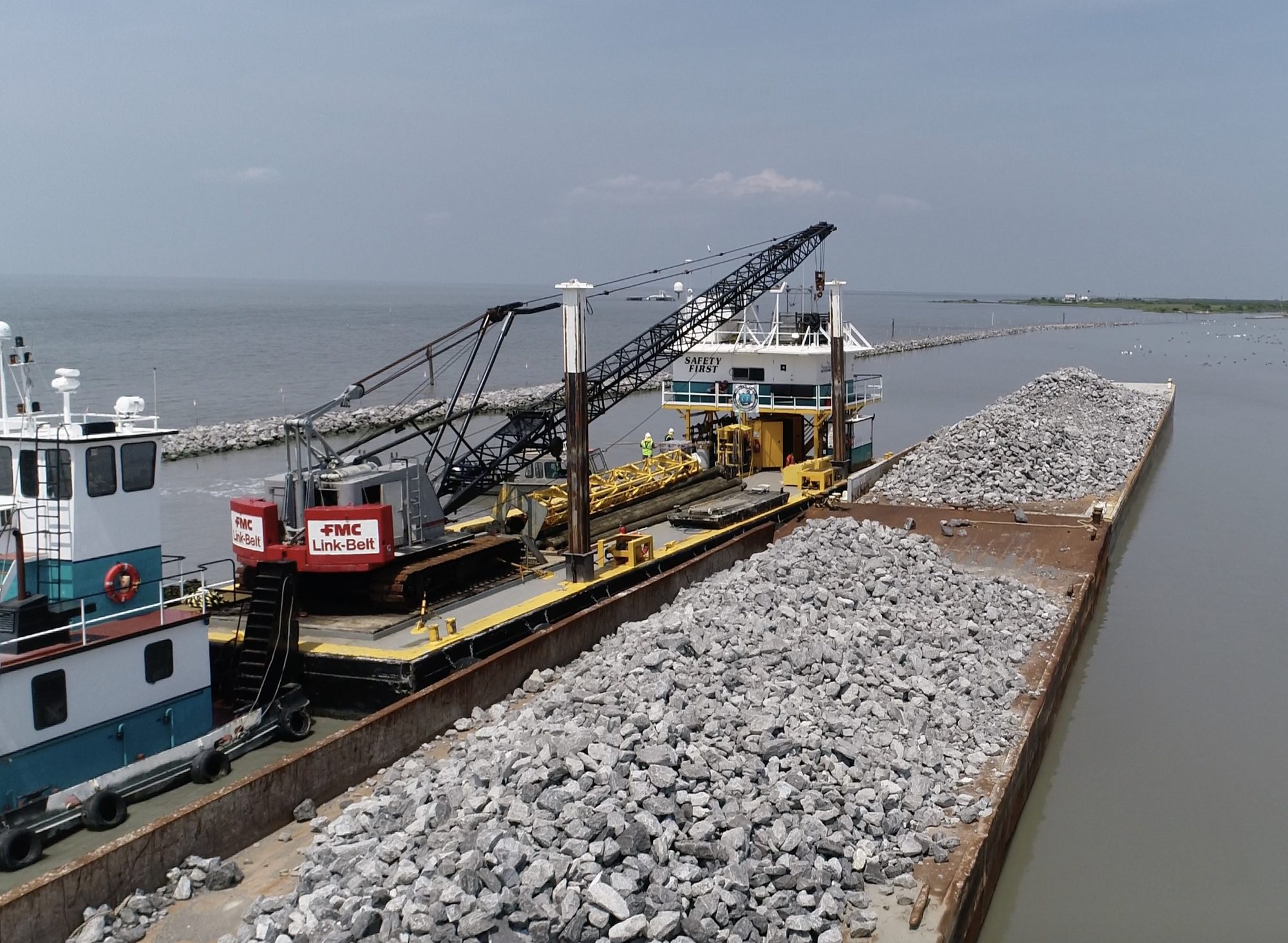 Bunk barge alongside a barge loaded with rock