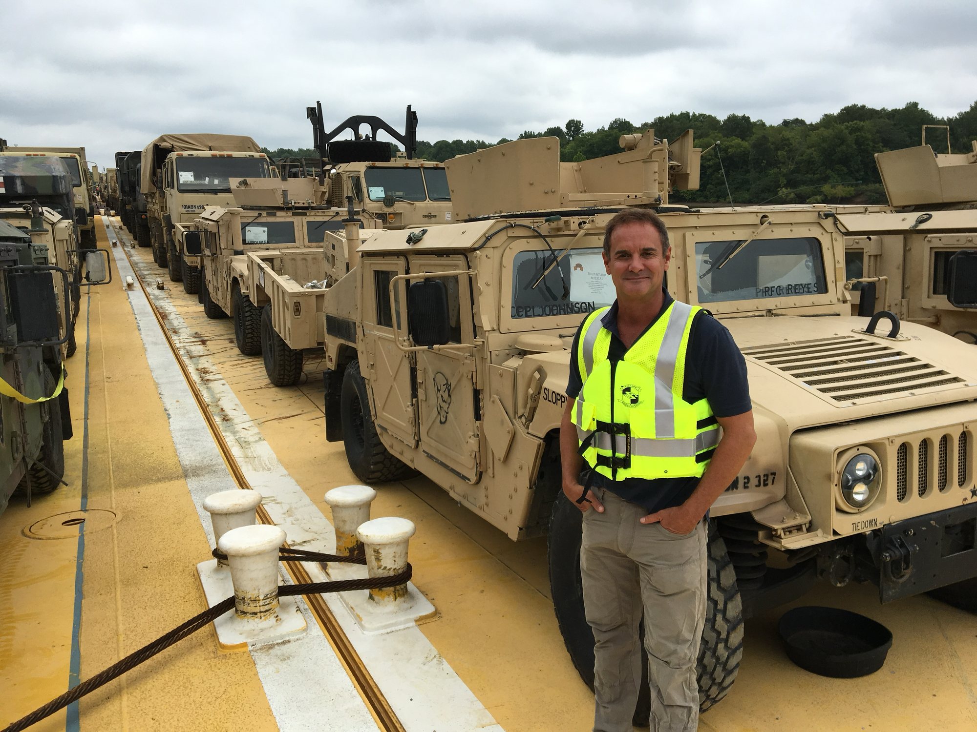 Dan Frankum on a Daulton barge loaded with military vehicles