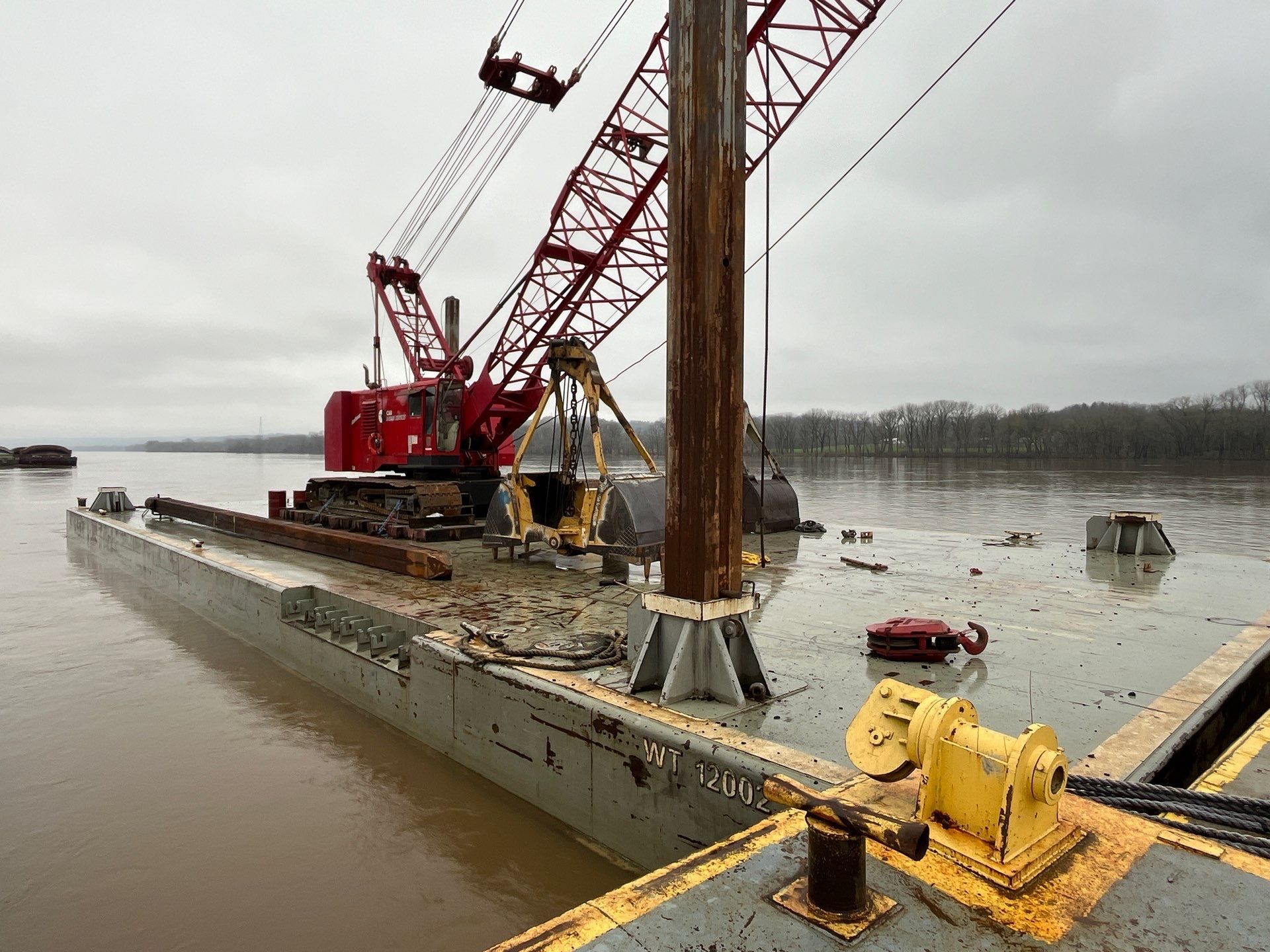 Crane working atop a Daulton spud barge